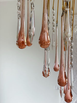 Rose gold teardrop-shaped chandelier against a white background