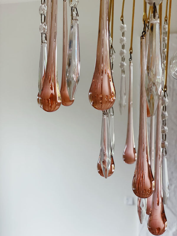 Rose gold teardrop-shaped chandelier against a white background