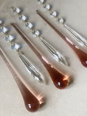 Rose gold hair pins with clear crystal elements on a light background