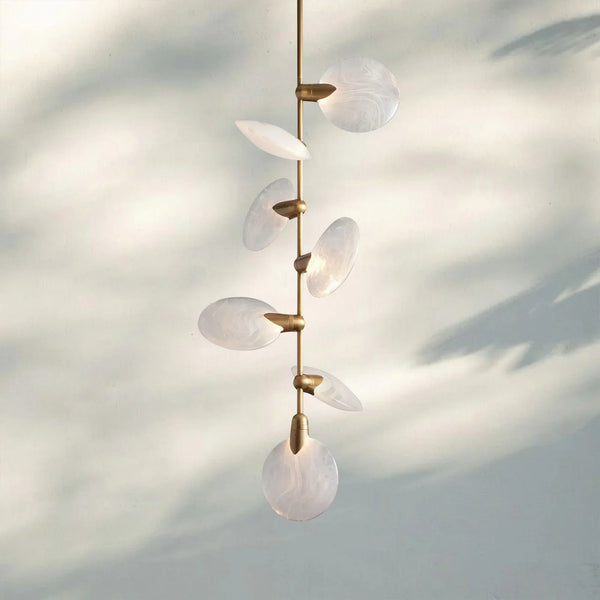 Close-up of Lyla Pendant with natural alabaster texture and gold details